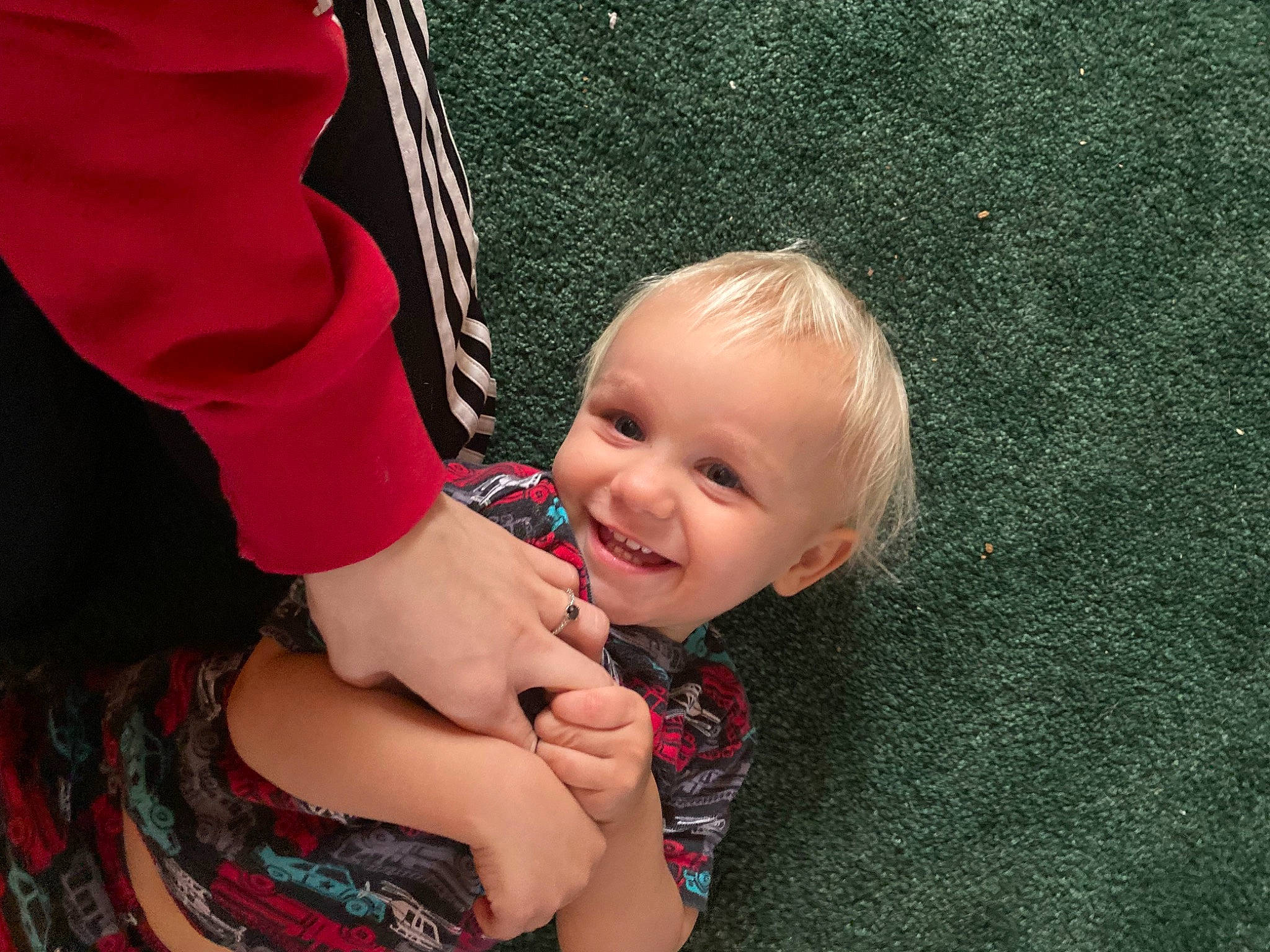 Jayce is registered to the contest to win money with this photo: baby, baby_toddler_clothing, child, flooring, fun, gesture, grass, happy, human_leg, joy, leisure, magenta, pattern, people_in_nature, person, plant, sitting, sleeve, smile, thumb