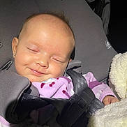 Olivia is registered to the contest to win money with this photo: baby, blanket, car, car_interior, carseat, clothing, coat, cushion, face, head, headrest, homedecor, jacket, newborn, person, photography, portrait, sleeping, transportation, vehicle