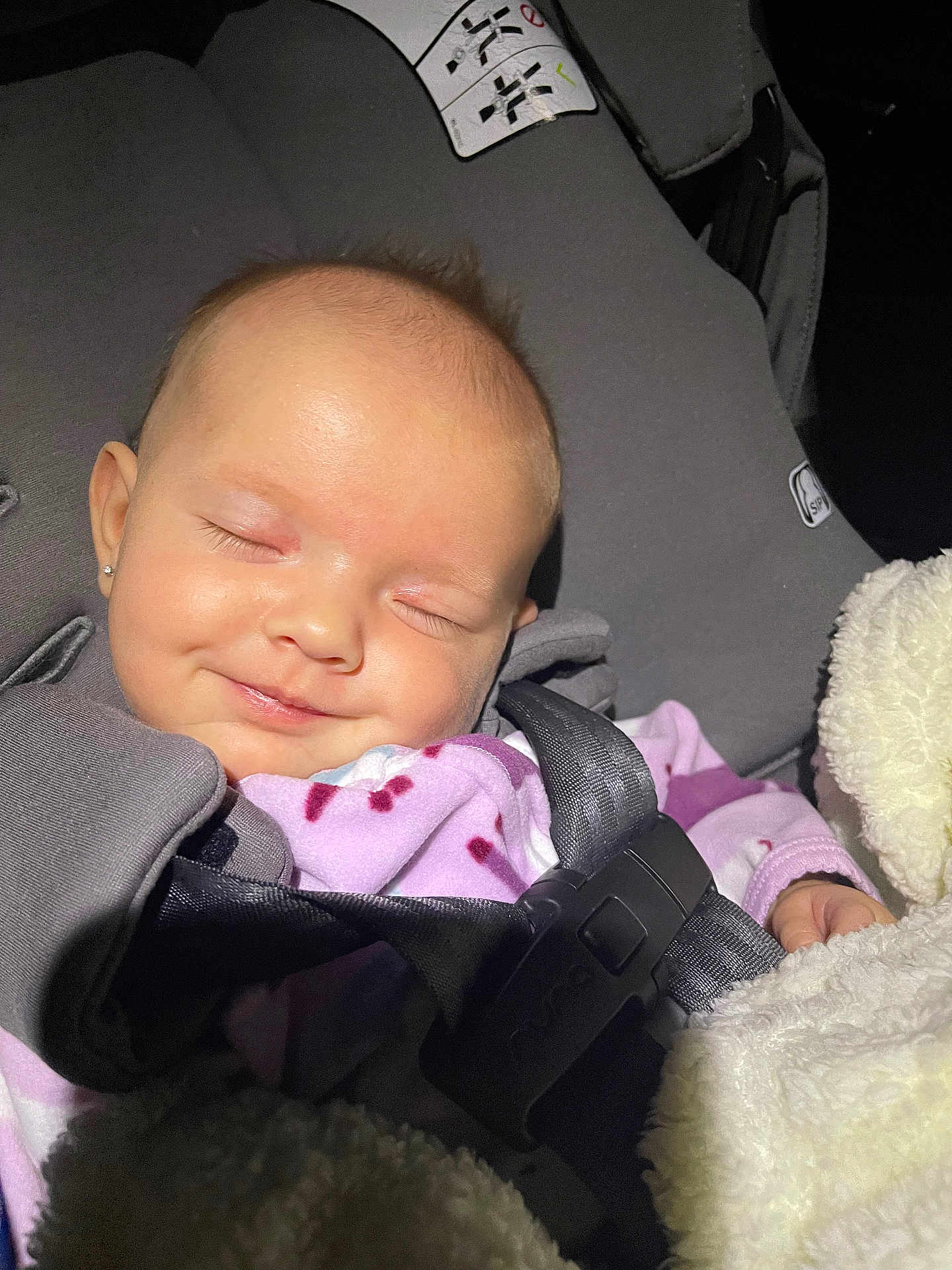 Olivia is registered to the contest to win money with this photo: baby, blanket, car, car_interior, carseat, clothing, coat, cushion, face, head, headrest, homedecor, jacket, newborn, person, photography, portrait, sleeping, transportation, vehicle