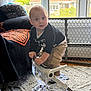 Ronan joined the competition — help win amazing prizes! toddler, child, indoor, baby_rocker, carpet, window, curtain, chair, blanket, clothing, person, face, hands, couch, home, toy, natural_light, curious, standing, house