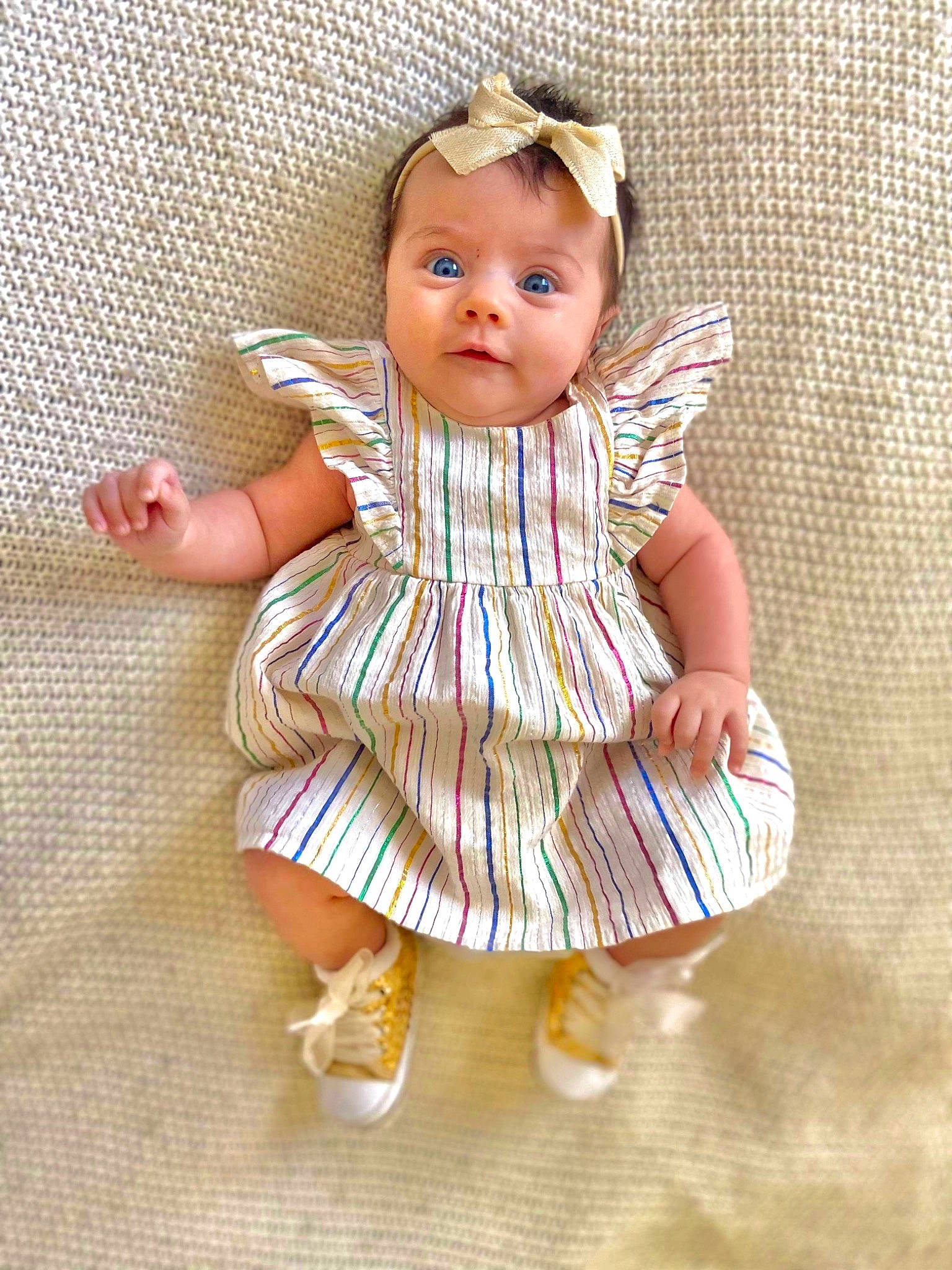 Elora is registered to the contest to win money with this photo: baby, baby_toddler_clothing, beauty, brown_hair, child, day_dress, dress, eye, fashion_accessory, fashion_design, iris, one_piece_garment, pattern, peach, person, ruffle, sleeve, sock, textile, toddler