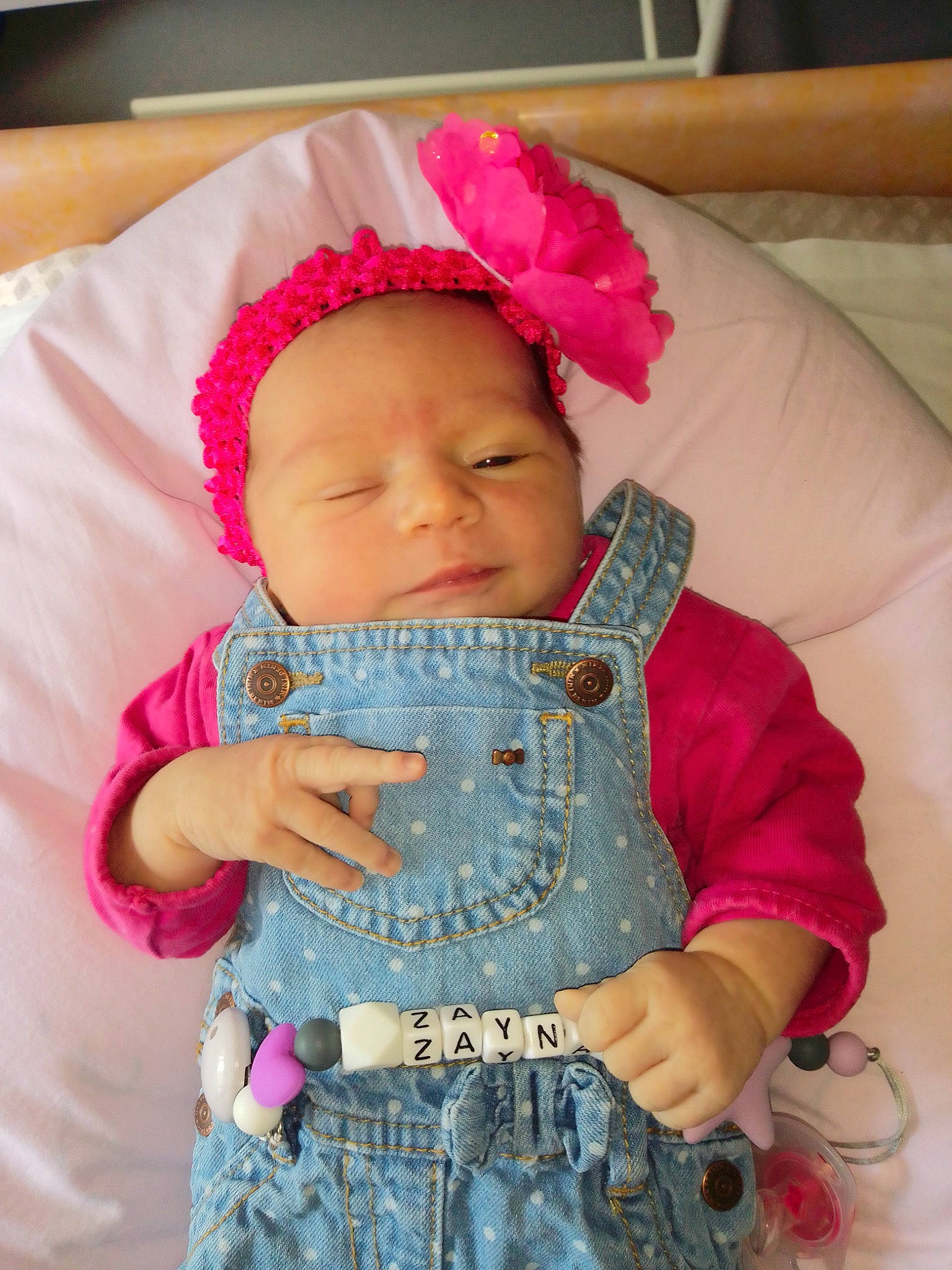 Zayna participe au concours pour gagner de l'argent avec cette photo : baby, baby_products, baby_toddler_clothing, cheek, child, hair_accessory, headgear, headwear, knitting, magenta, person, pink, product, skin, textile, toddler