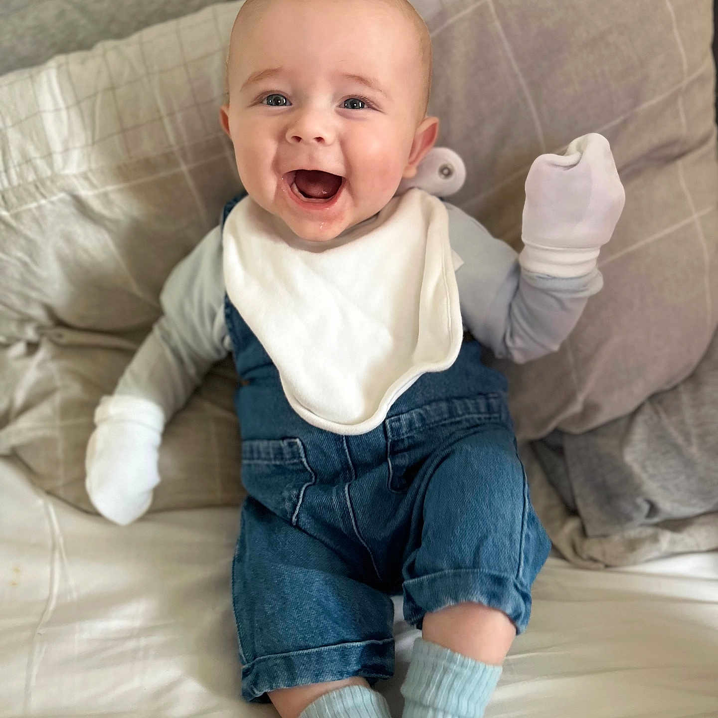 Ollie is registered to the contest to win money with this photo: baby, babylaughing, clothing, face, happy, head, hosiery, jeans, pants, person, photography, portrait, sitting, sock