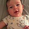 Sophia is registered to the contest to win money with this photo: apparel, baby, bed, child, cute, face, fox_print, hand, indoors, infant, lying_down, onesie, pattern, person, portrait, sheet, skin, sleepwear, smiling, young