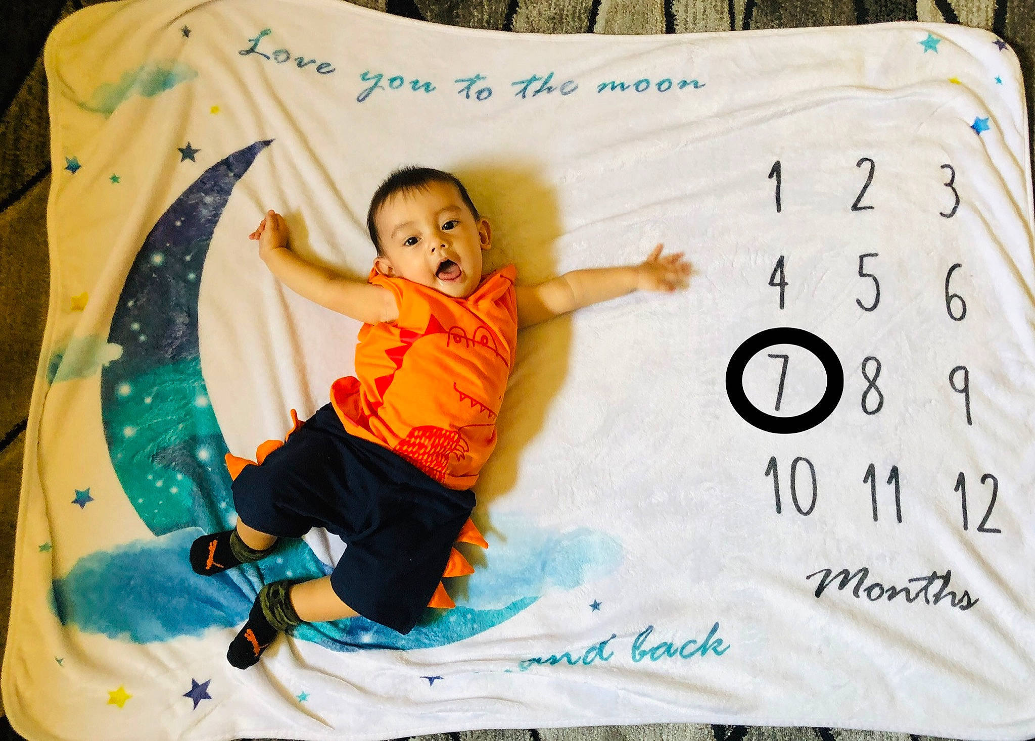 Gianni is registered to the contest to win money with this photo: baby, baby_toddler_clothing, bedding, child, comfort, font, fun, green, happy, leisure, linens, pattern, person, rectangle, room, sitting, sleeve, surprise, t_shirt, textile