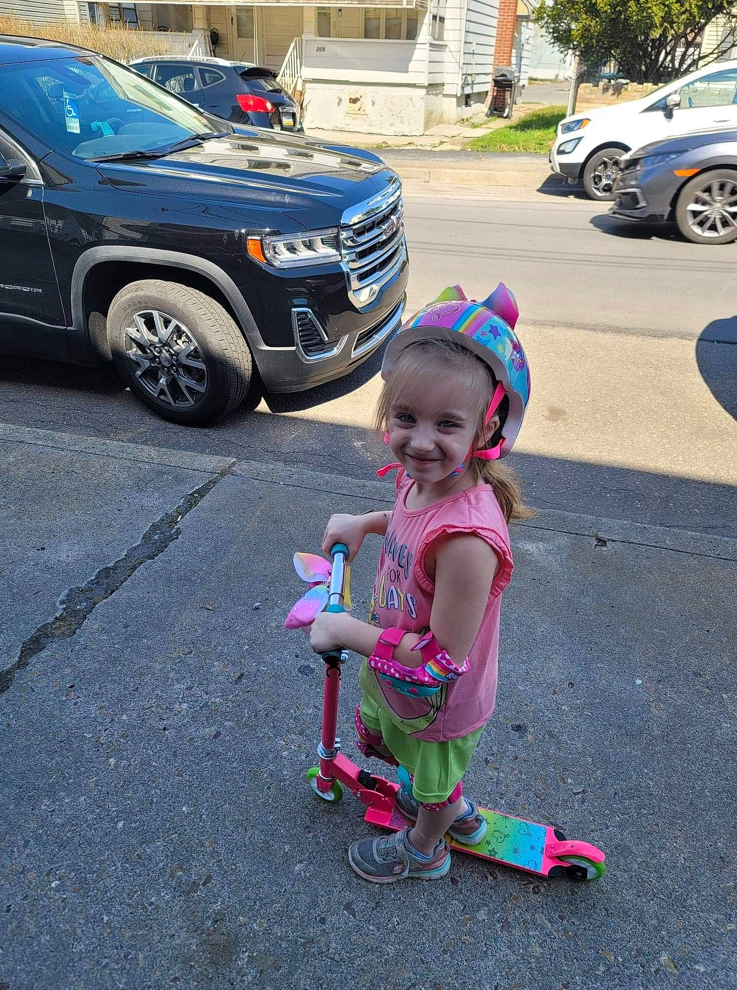 Cadence is registered to the contest to win money with this photo: asphalt, automotive_design, automotive_exterior, automotive_fog_light, automotive_lighting, automotive_tire, automotive_wheel_system, bumper, car, grille, joy, land_vehicle, motor_vehicle, parking, person, road, smile, tire, toddler, vehicle