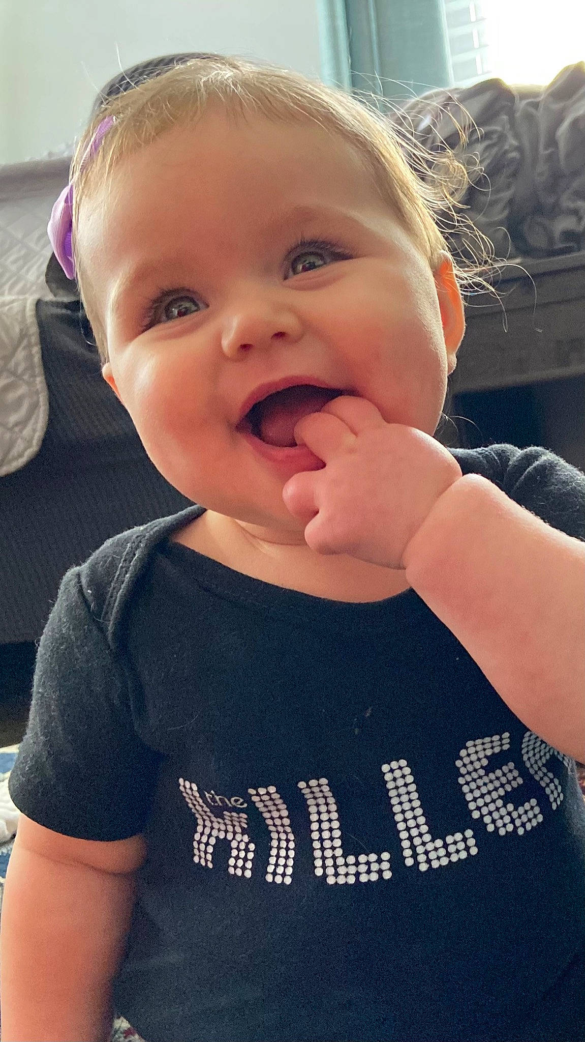 Joni is registered to the contest to win money with this photo: baby, baby_toddler_clothing, cheek, clothing, cool, eye, finger, gesture, happy, human_body, iris, lip, mouth, neck, nose, person, skin, sleeve, smile, toddler