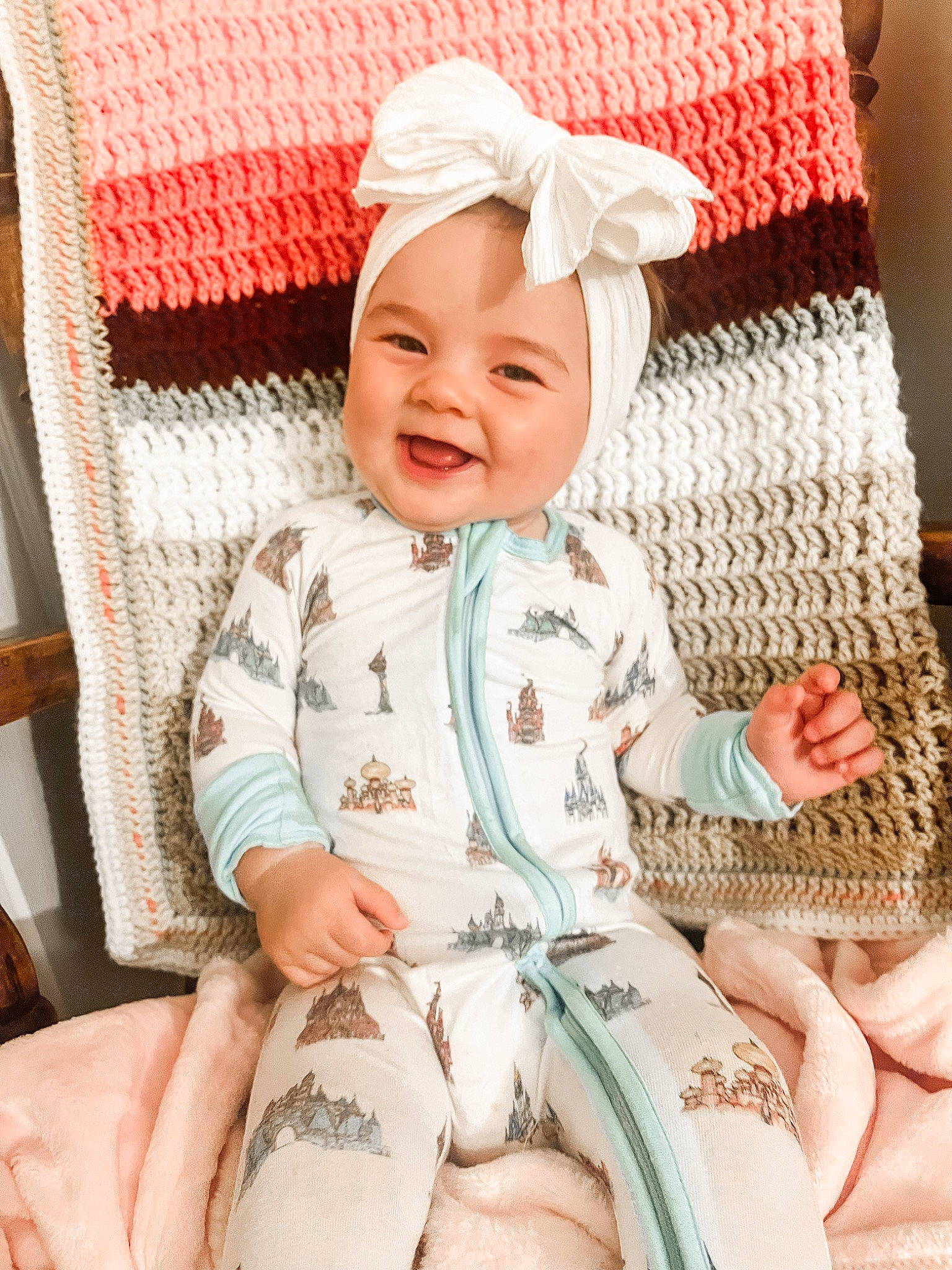 Sunny is registered to the contest to win money with this photo: baby, baby_laughing, baby_sleeping, baby_toddler_clothing, child, comfort, face, happy, headwear, joy, linens, outerwear, pattern, person, product, sitting, skin, sleeve, smile, textile