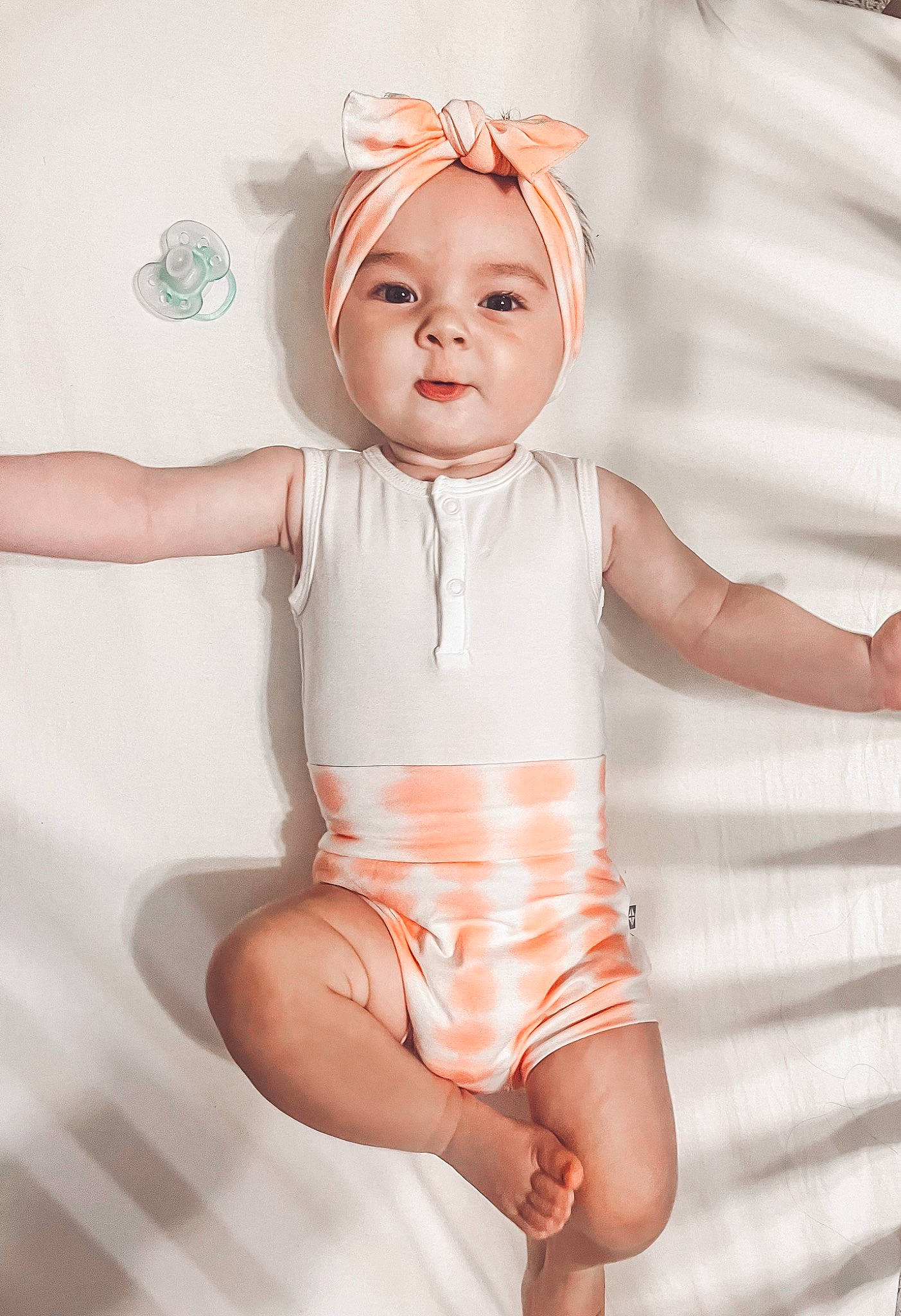 Sunny is registered to the contest to win money with this photo: abdomen, baby_toddler_clothing, chest, finger, gesture, human_body, human_leg, joint, knee, leg, person, pink, skin, stomach, thigh, thumb, toddler, toy, trunk, waist