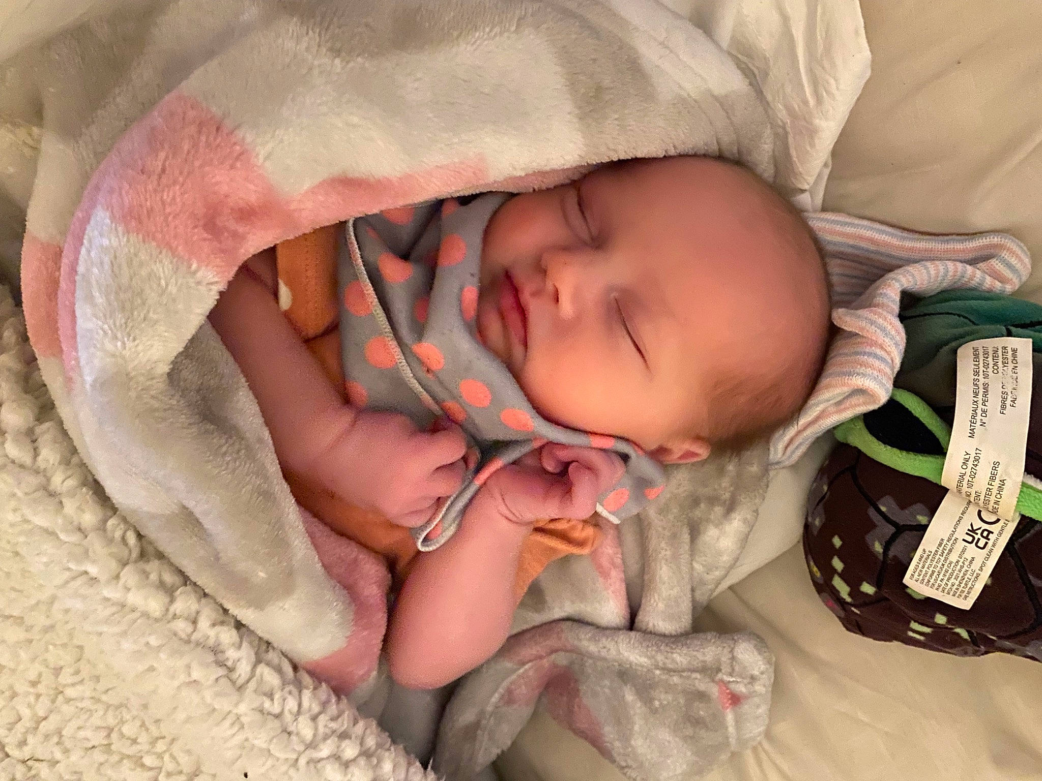 Harper is registered to the contest to win money with this photo: arm, baby, baby_sleeping, baby_toddler_clothing, cheek, child, comfort, eye, finger, hand, headgear, linens, lip, mouth, nail, person, skin, smile, textile, toddler