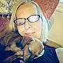 Windsor joined the competition — help win amazing prizes! blonde_hair, casual, chair, closeup, comfort, couch, cozy, dog, glasses, home, human, indoor, pet, portrait, puppy, relaxation, resting, sleeping, smile, woman