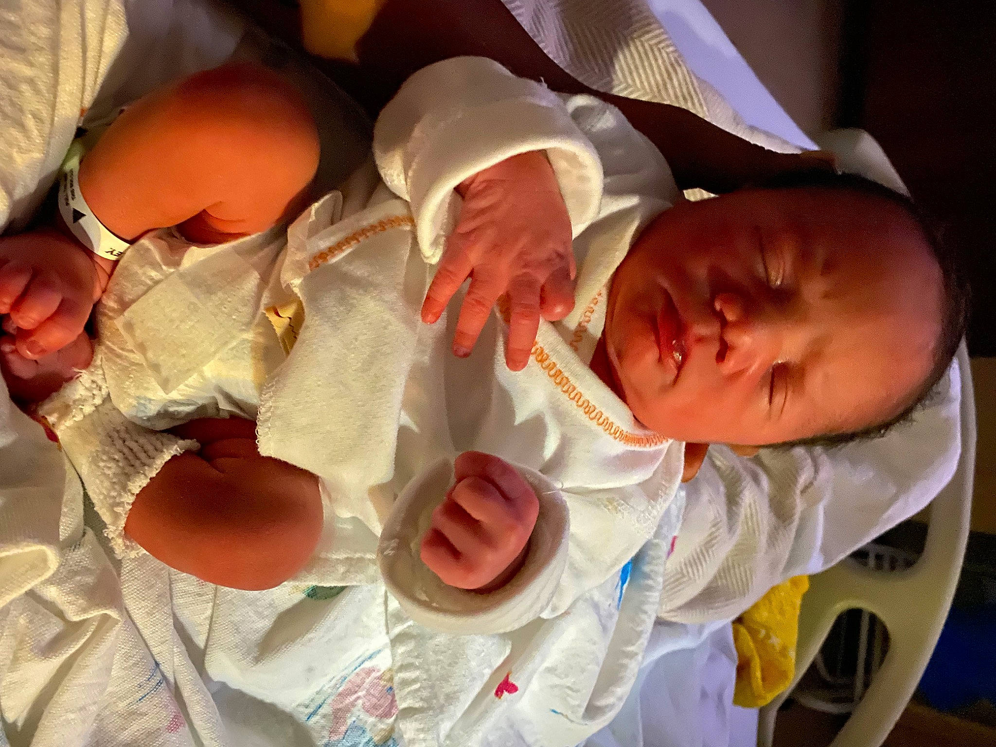 Jamani is registered to the contest to win money with this photo: arm, baby, baby_products, baby_toddler_clothing, child, comfort, event, facial_expression, finger, gesture, human_body, mouth, nail, orange, person, product, room, skin, sorrow, tableware