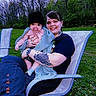 Blaire joined the competition — help win amazing prizes! baby, blanket, casual_clothing, child, family, grass, greenery, happy, hat, lawn_chair, nature, outdoor, pacifier, person, portrait, smile, spring, tattoo, trees, woman