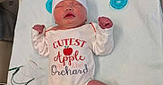 Blaire is registered to the contest to win money with this photo: baby, baby_clothes, blanket, cute, hat, hospital, infant, lying_down, medical_wires, newborn, onesie, pacifier, person, pink_skin, resting, scrunchie, sleeping, small_feet, small_hands, socks