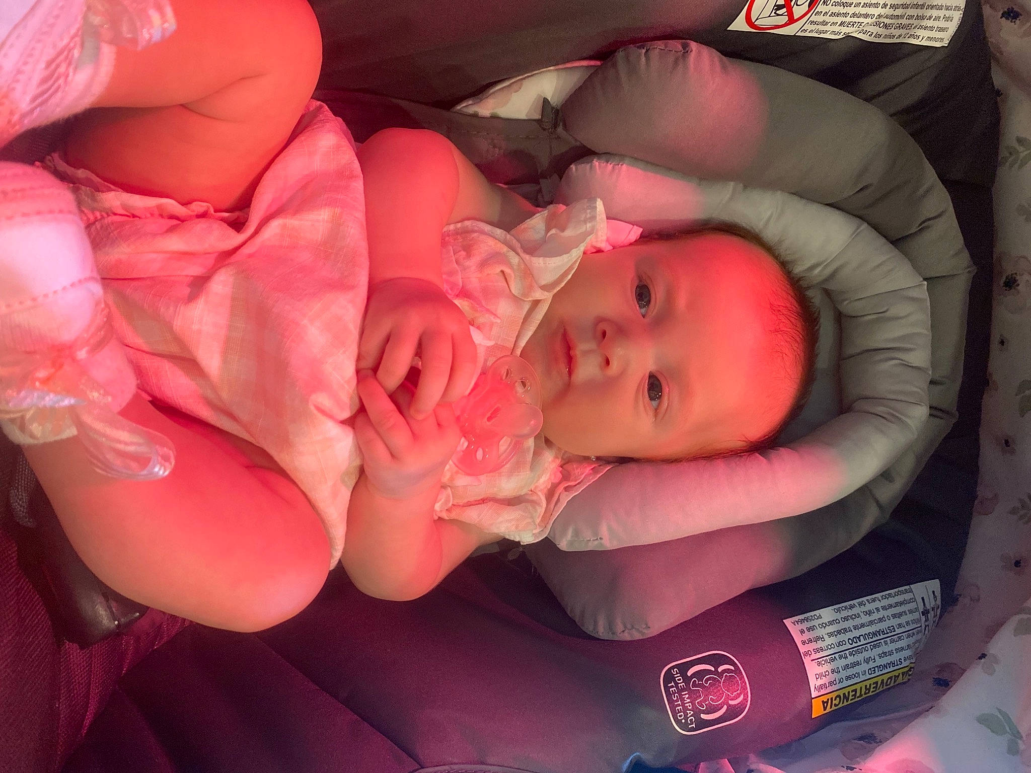 Kinsley is registered to the contest to win money with this photo: arm, baby, baby_toddler_clothing, cheek, child, comfort, facial_expression, finger, hand, helmet, human_body, lip, magenta, mouth, nail, orange, person, petal, pink, skin