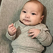 Maverick joined the competition — help win amazing prizes! baby, infant, child, face, hands, clothing, gray, knitwear, portrait, cute, cozy, expression, sitting, indoor, closeup, skin, head, eyes, person, young