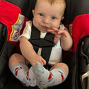 Waylon joined the competition — help win amazing prizes! automobile, baby, black_seat, blue_eyes, car_seat, child, happy, indoors, infant, photography, portrait, red_padding, safety_harness, short_hair, sitting, smiling, striped_socks, vehicle, waving, white_shirt