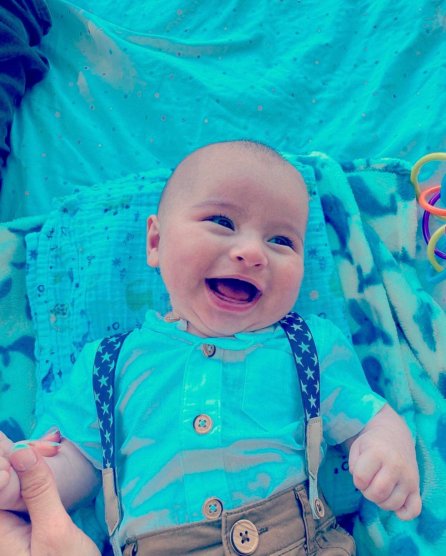Sullivan is registered to the contest to win money with this photo: aqua, azure, baby, baby_laughing, baby_toddler_clothing, blue, cheek, child, electric_blue, eye, face, fun, gesture, happy, iris, person, pink, skin, sleeve, smile