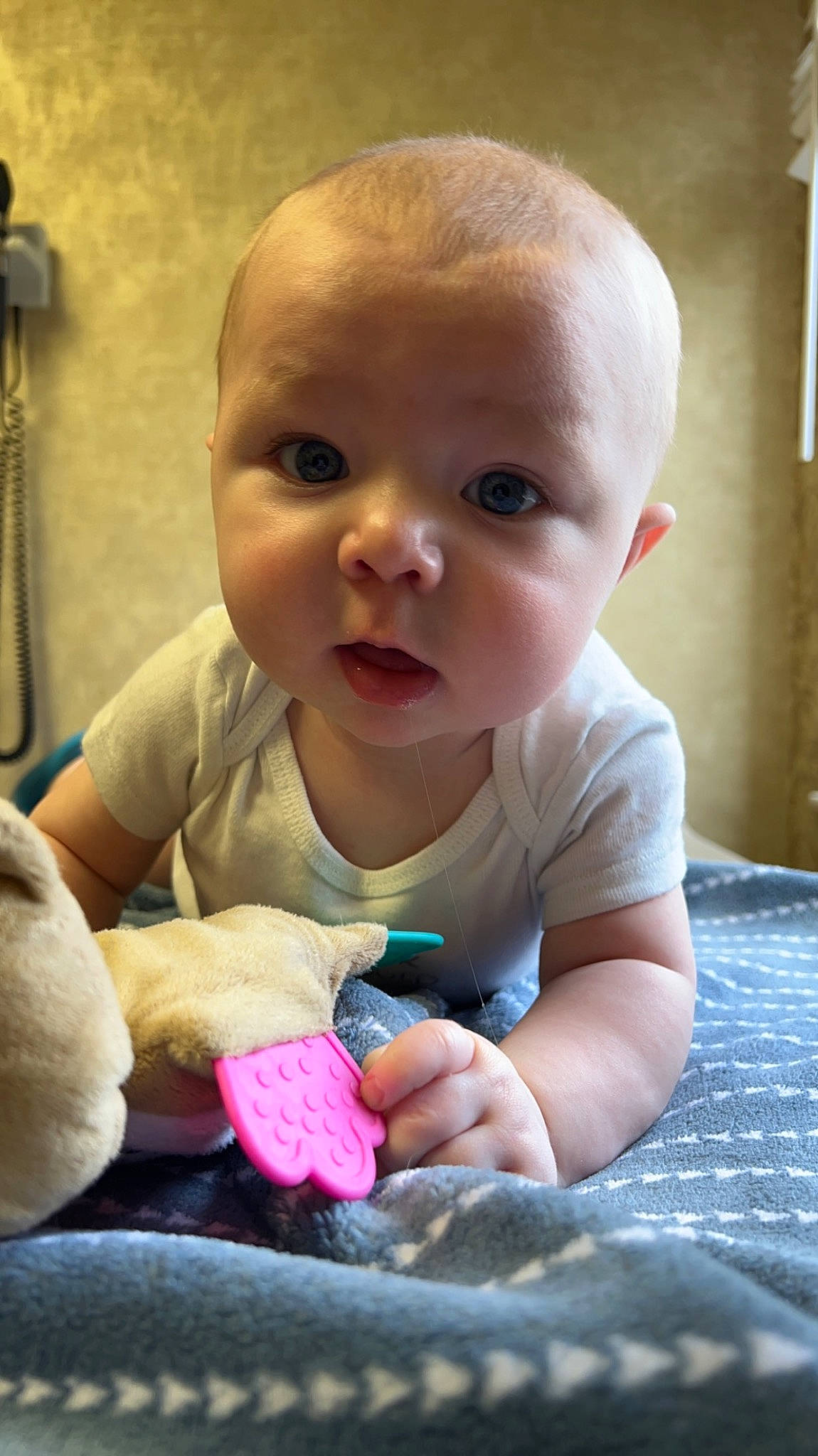 Bradley is registered to the contest to win money with this photo: arm, baby, baby_products, baby_toddler_clothing, cheek, child, comfort, eye, finger, flooring, happy, human_body, iris, mouth, nose, person, sitting, skin, toddler, toy