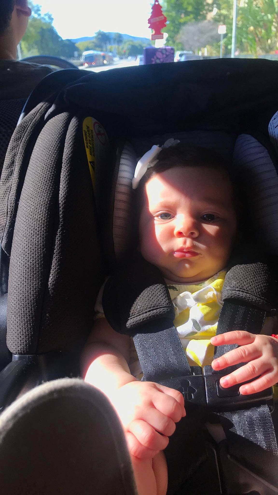 Leyla is registered to the contest to win money with this photo: auto_part, baby, baby_carriage, baby_in_car_seat, car, car_seat, child, driving, finger, hand, person, product, seat_belt, skin, smile, steering_wheel, toddler, vacation