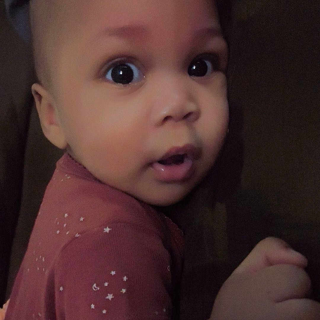 Gianni is registered to the contest to win money with this photo: baby, bodypart, cap, clothing, couch, face, finger, furniture, hand, happy, hat, head, newborn, person, photography, portrait, selfie, smile, t_shirt, toy