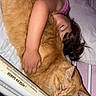 Popcorn is registered to the contest to win money with this photo: bed, bedroom, blanket, cat, child, cozy, cuddling, family, fluffy, indoors, long_hair, nap, newspaper, orange_cat, pet, pillow, pink, portrait, relaxed, sleeping