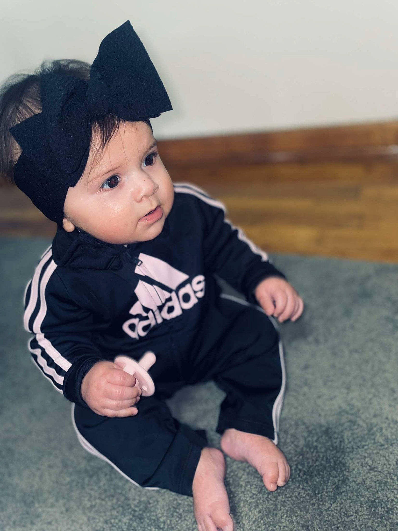 Cecilia is registered to the contest to win money with this photo: baby, baby_toddler_clothing, baseball_cap, beanie, cap, cheek, child, costume_hat, eye, fashion_accessory, flash_photography, flooring, gesture, grass, happy, hat, headwear, person, sitting, sleeve