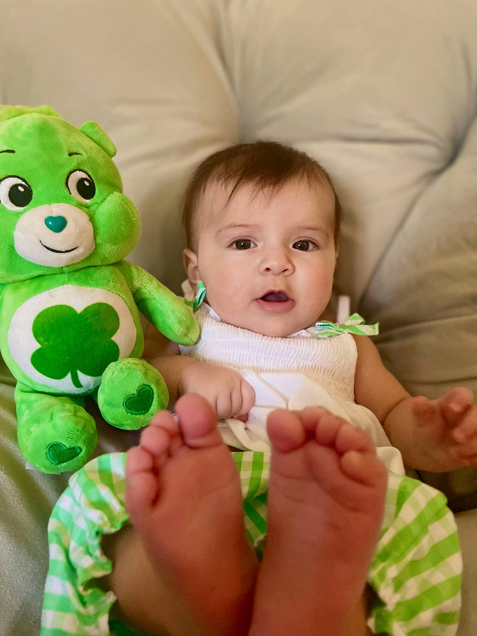 Cecilia is registered to the contest to win money with this photo: arm, baby, baby_toddler_clothing, cheek, comfort, couch, face, facial_expression, finger, gesture, grass, green, hairstyle, hand, happy, human_body, interaction, person, skin, thumb