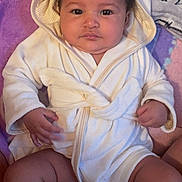 Ivanka joined the competition — help win amazing prizes! baby, blanket, calm, child, chubby_legs, cozy, curious, cute, eyes, face, hands, hooded_robe, indoor, infant, pink_blanket, portrait, purple_blanket, sitting, soft_texture, white_clothing