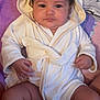 baby, blanket, calm, child, chubby_legs, cozy, curious, cute, eyes, face, hands, hooded_robe, indoor, infant, pink_blanket, portrait, purple_blanket, sitting, soft_texture, white_clothing