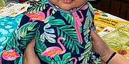Ivanka joined the competition — help win amazing prizes! baby, blanket, blue_hat, child, colorful_clothing, cute, eyes, face, flamingo_pattern, hand, hat, holding, indoor, kitchen, person, portrait, sitting, skin, table, toddler