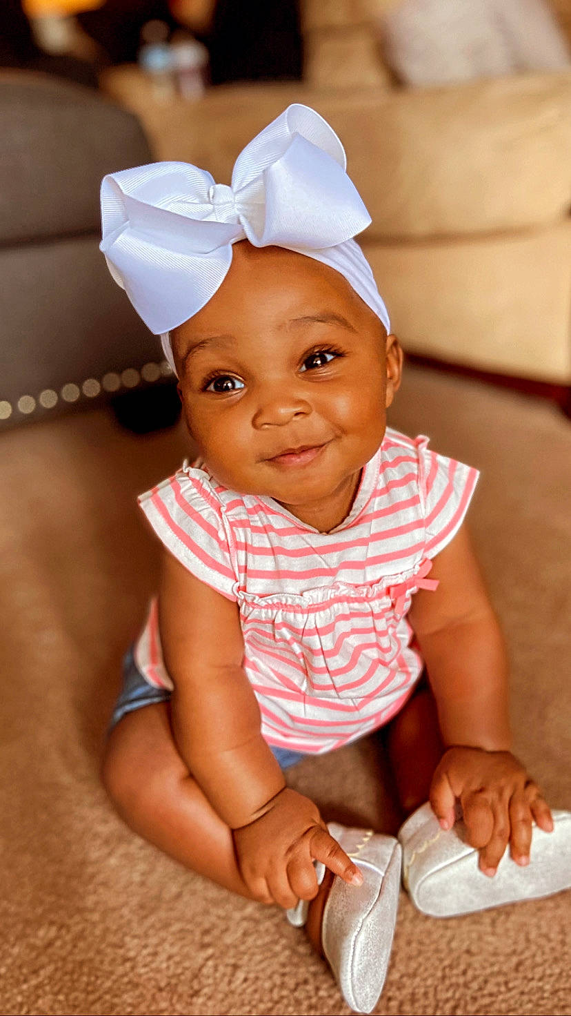 Kaidence is registered to the contest to win money with this photo: baby, baby_toddler_clothing, child, fashion_accessory, happy, headgear, joy, person, sitting, skin, smile, toddler