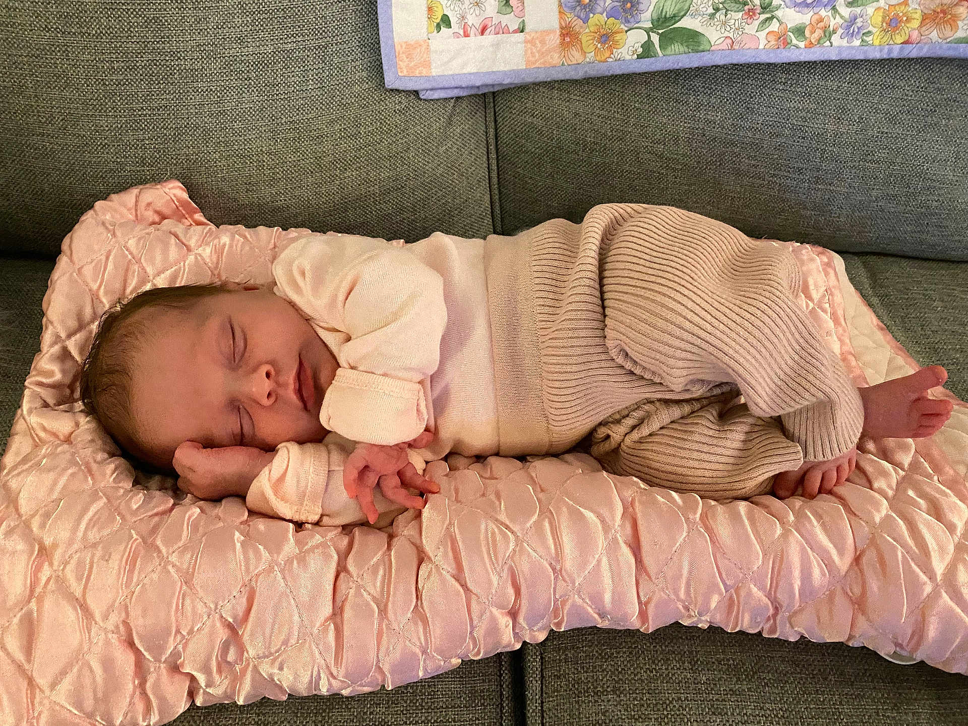 Penelope joined the competition — help win amazing prizes! baby, newborn, sleeping, infant, pink_cushion, pastel_clothing, couch, blanket, floral_pattern, soft_fabric, cozy, resting, cute, peaceful, indoors, portrait, child, tiny_hands, tiny_feet, relaxing