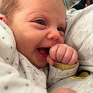 Maëlle participe au concours pour gagner de l'argent avec cette photo : baby, infant, close_up, smiling, hand, face, eyes, clothing, white, dots, cute, joy, innocence, skin, happy, newborn, portrait, soft, warm, babywear