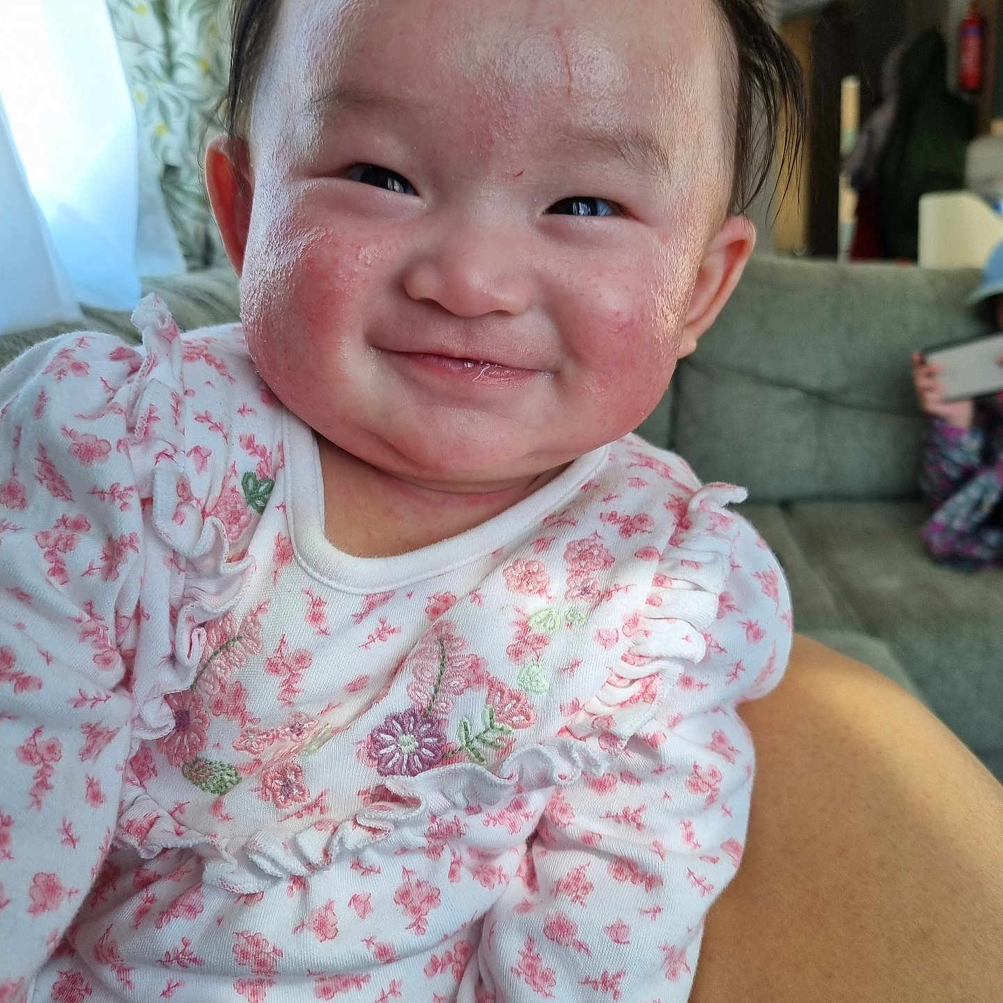 Arora is registered to the contest to win money with this photo: architecture, baby, building, couch, electronics, face, furniture, happy, head, homedecor, indoors, laughing, livingroom, mobilephone, person, phone, photography, portrait, room, smile