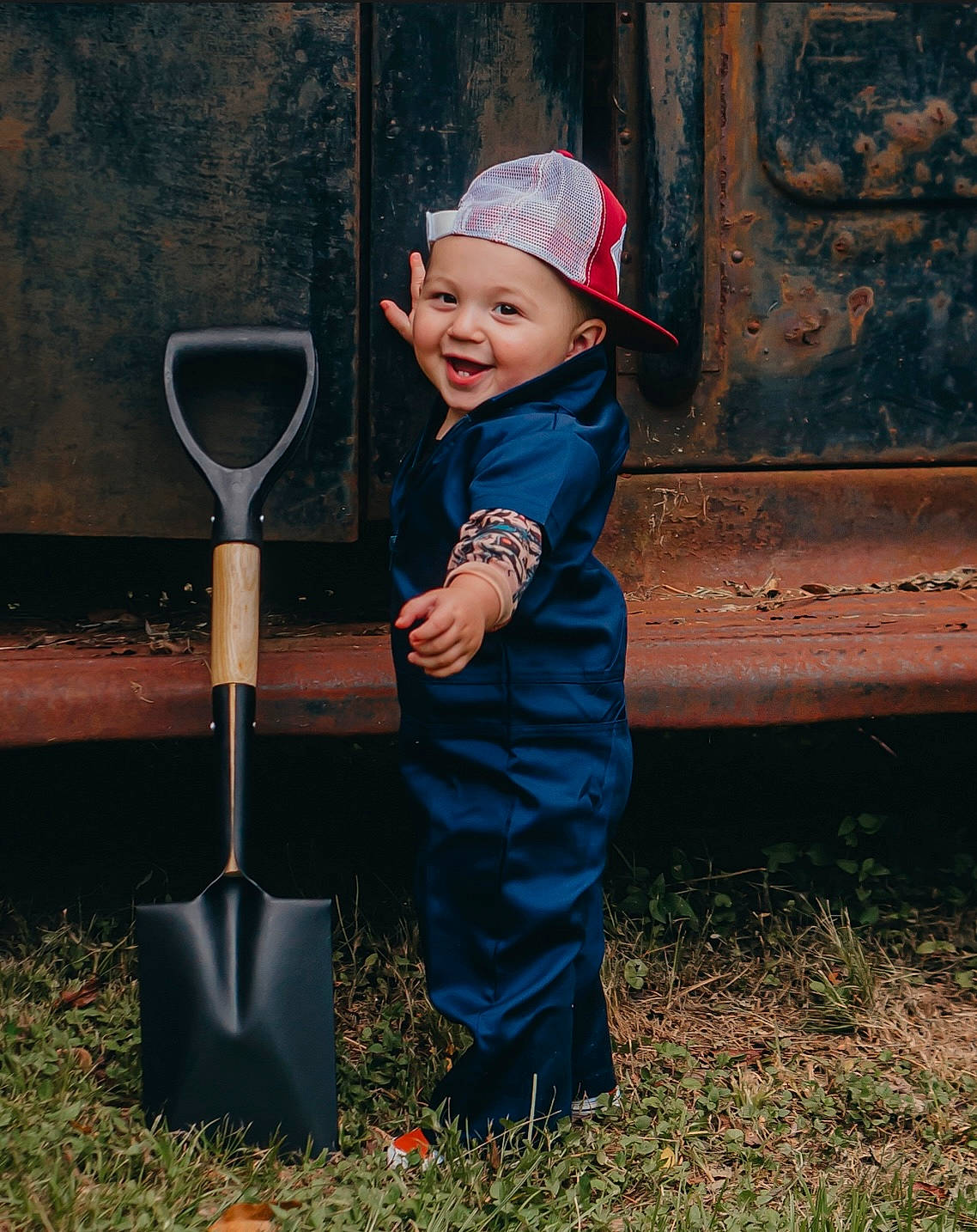 Callen is registered to the contest to win money with this photo: baby_toddler_clothing, baseball_cap, cap, child, electric_blue, flash_photography, fun, garden_tool, grass, hat, headwear, joy, leisure, people_in_nature, person, recreation, shovel, smile, soil, standing