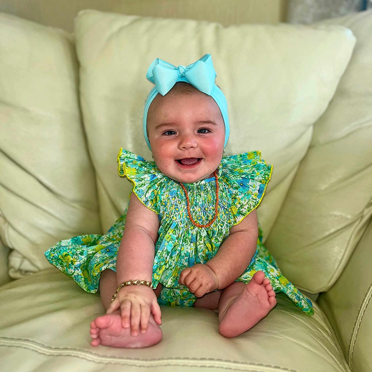 Marylou is registered to the contest to win money with this photo: accessories, baby, babylaughing, bracelet, clothing, couch, cushion, dress, face, furniture, happy, head, homedecor, jewelry, necklace, person, photography, portrait, sitting, smile