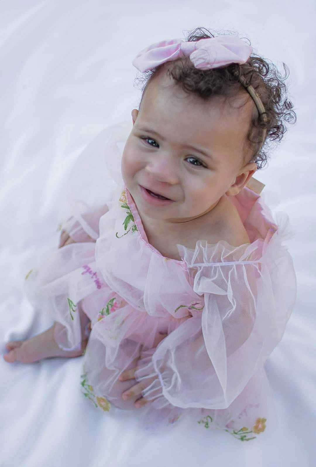 Alaia is registered to the contest to win money with this photo: baby, baby_toddler_clothing, bridal_accessory, bridal_clothing, dress, embellishment, event, face, flash_photography, happy, headgear, headpiece, iris, joy, person, petal, pink, skin, sleeve, smile