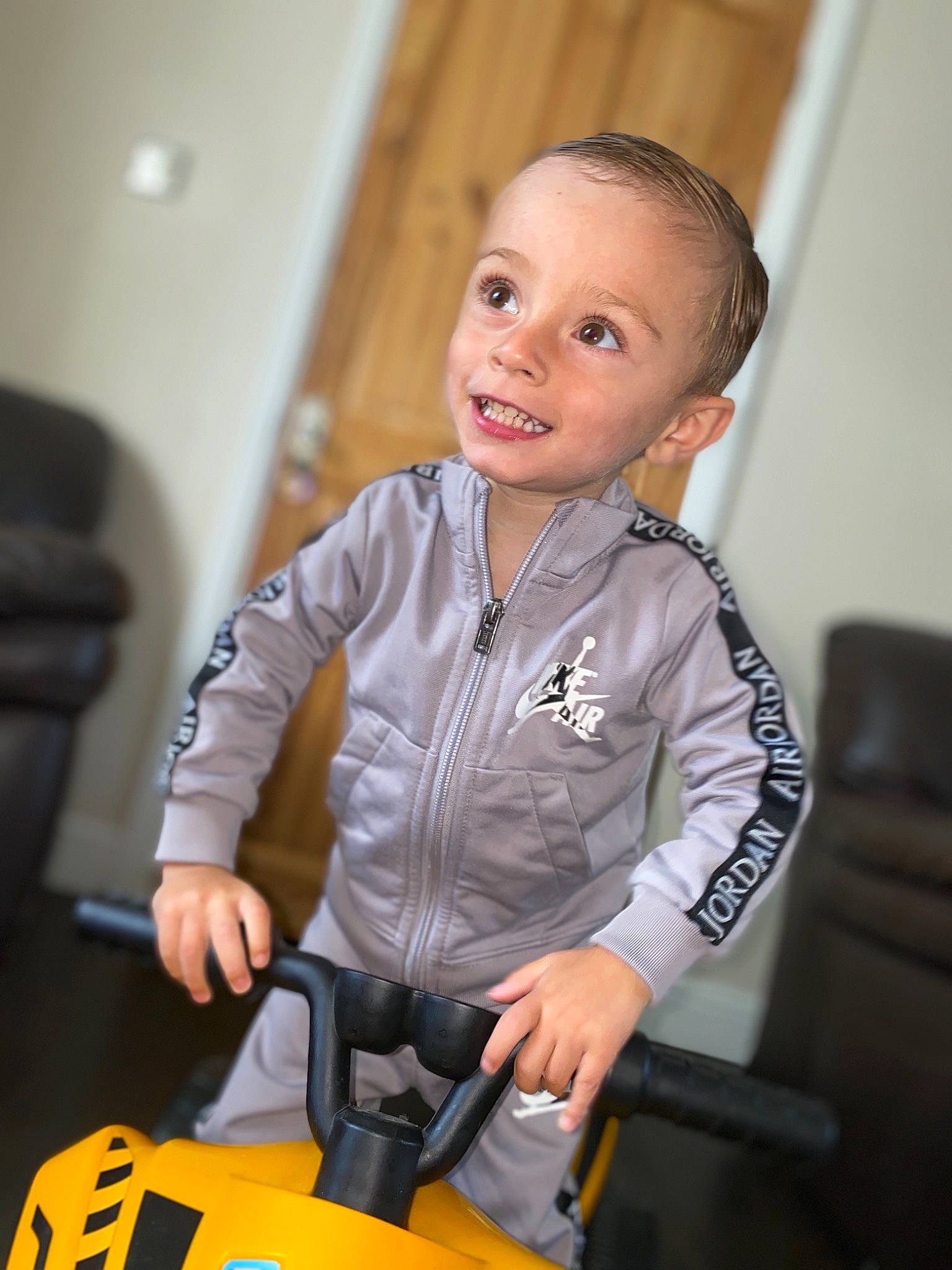 Bowen is registered to the contest to win money with this photo: baby, chair, child, event, fun, gadget, jeans, job, joy, person, personal_protective_equipment, recreation, room, service, sitting, sleeve, smile, t_shirt, table, tie