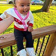 Dezire joined the competition — help win amazing prizes! toddler, child, smiling, curly_hair, hair_clips, white_shoes, lace_socks, cardigan, black_pants, wooden_railing, hand, outdoor, grass, tree, car, sunlight, porch, happy, person, daytime