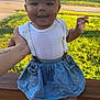 Dezire joined the competition — help win amazing prizes! baby, child, smiling, outdoor, grass, sunlight, white_bow, denim_skirt, suspenders, white_top, hand, person, happy, face, headband, footwear, sock, wooden_rail, house, tree
