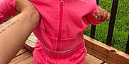 Dezire is registered to the contest to win money with this photo: toddler, child, pink_clothing, tracksuit, bow, outdoor, deck, hand, holding, suburban, car, house, grass, wood, sneakers, person, face, curious, smile, portrait