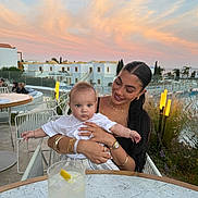Smokey joined the competition — help win amazing prizes! baby, woman, outdoor, sunset, table, drink, glass, pool, plant, smile, person, bracelet, necklace, watch, chair, clothing, face, sky, building, nature