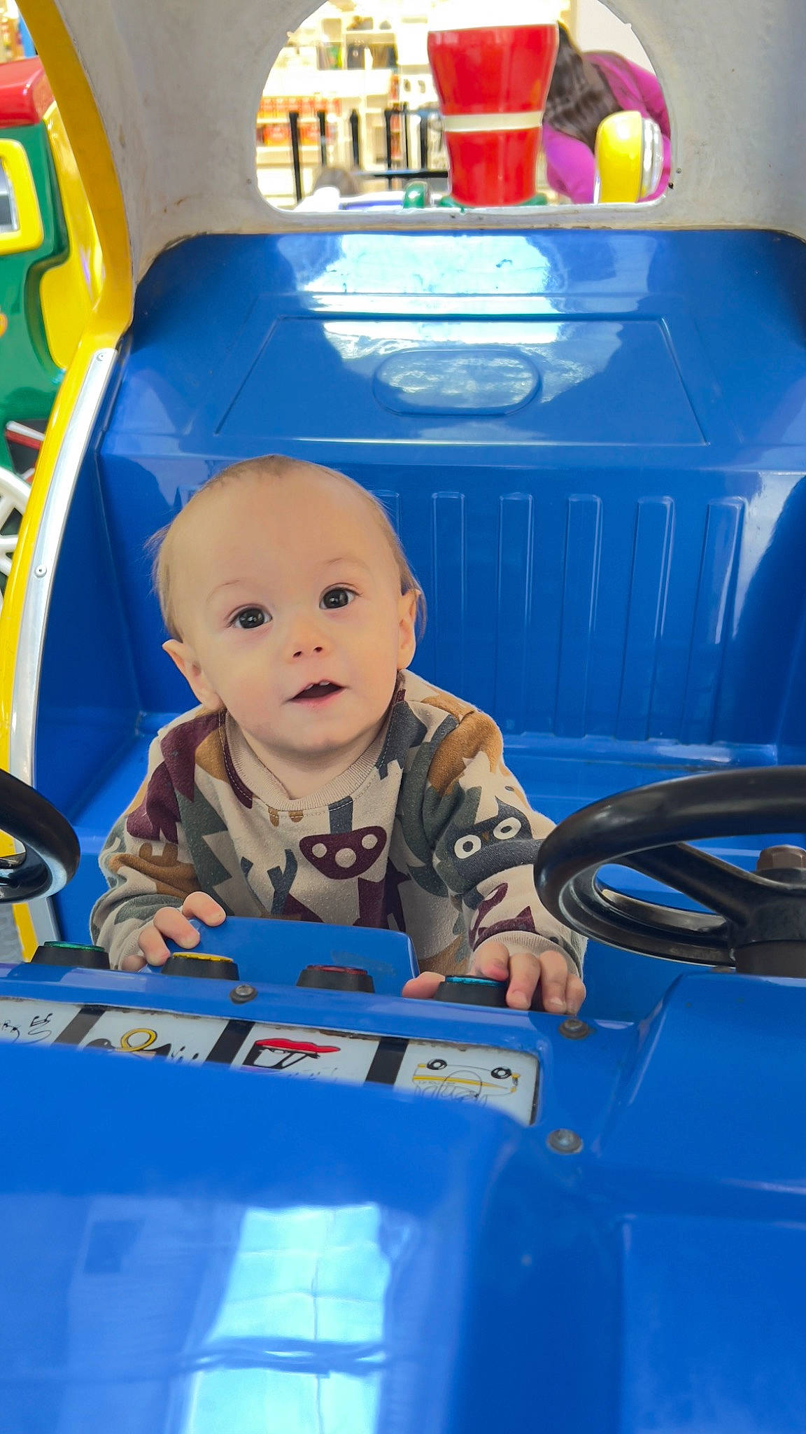 Ryder is registered to the contest to win money with this photo: automotive_design, automotive_exterior, automotive_tire, baby, blue, bumper, child, electric_blue, fender, fun, hood, leisure, mode_of_transport, motor_vehicle, person, product, toddler, vehicle, vehicle_door, windshield