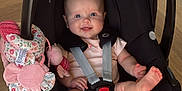 Lottie is registered to the contest to win money with this photo: baby, car_seat, child, cute, face, feet, floor, floral, happy, indoor, infant, maxi_cosi, person, pink, playful, sitting, smiling, straps, toy, wooden_floor