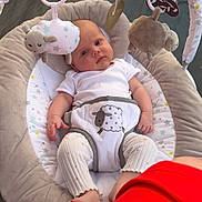 Lottie is registered to the contest to win money with this photo: baby, bouncer, child, comfort, cute, fabric, face, foot, hand, indoor, infant, looking, person, plush_toy, relaxing, sheep, soft_toy, star_pattern, toy_mobile, white_clothing
