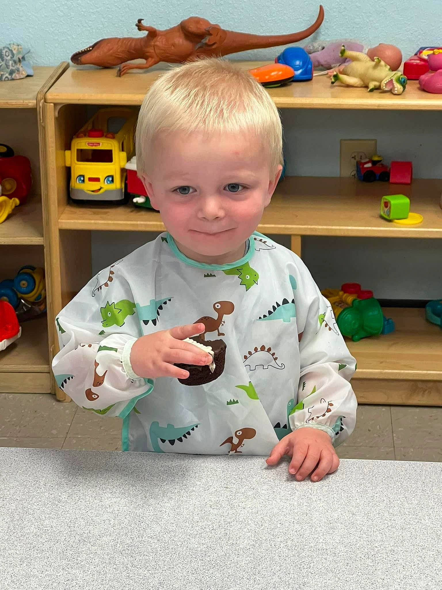 Levi is registered to the contest to win money with this photo: baby, baby_toddler_clothing, bookcase, chair, child, flooring, fun, happy, house, joy, learning, person, play, room, shelf, shelving, sitting, t_shirt, toddler, toy