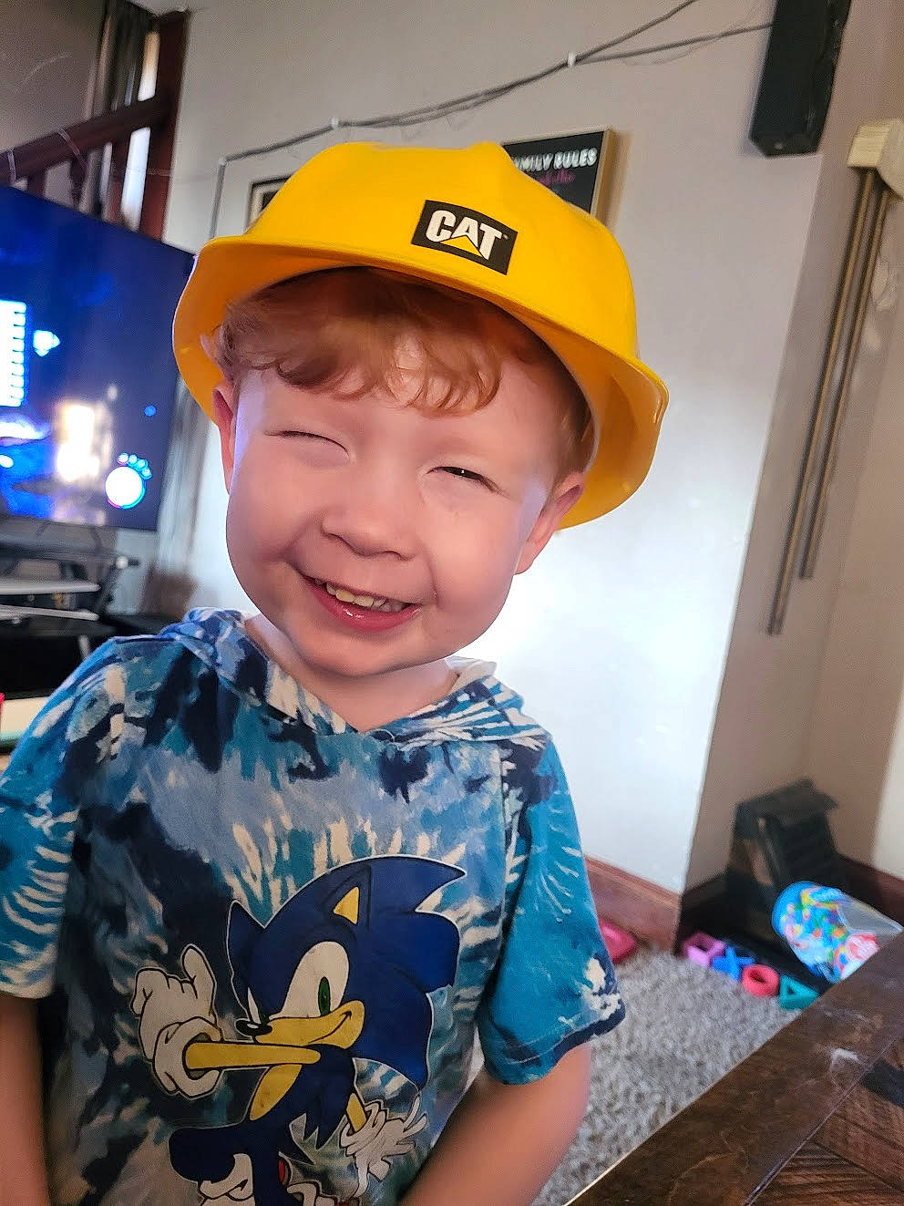 Sage is registered to the contest to win money with this photo: baseball_cap, cap, child, cool, electric_blue, fashion_accessory, fun, happy, hard_hat, headgear, helmet, joy, person, personal_protective_equipment, recreation, sleeve, smile, t_shirt, toddler, uniform