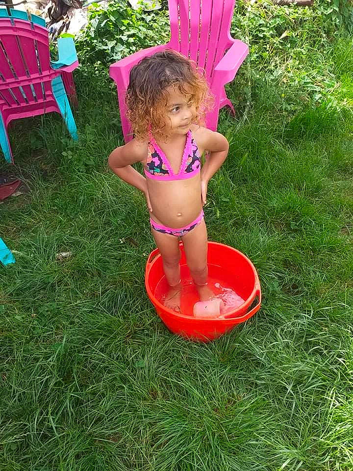 ImaË participe au concours pour gagner de l'argent avec cette photo : chair, child, fun, garden, grass, lawn_ornament, leisure, magenta, people_in_nature, person, pink, plant, play, recreation, swimwear, terrestrial_plant, thigh, toddler, toy, vacation