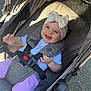 baby, bow_headband, buckle, canopy, carriage, child, clothing, happy, harness, headband, infant, pavement, portrait, purple_pants, seat, shadow, smile, stroller, sunlight, wheel
